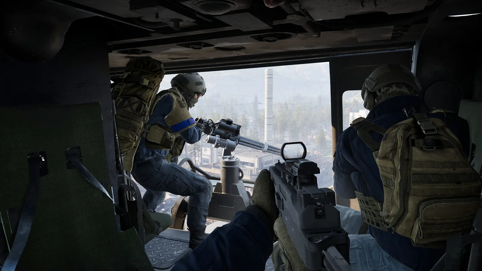 WARDOGS door gunner firing a mounted weapon from a helicopter side seat above the zone